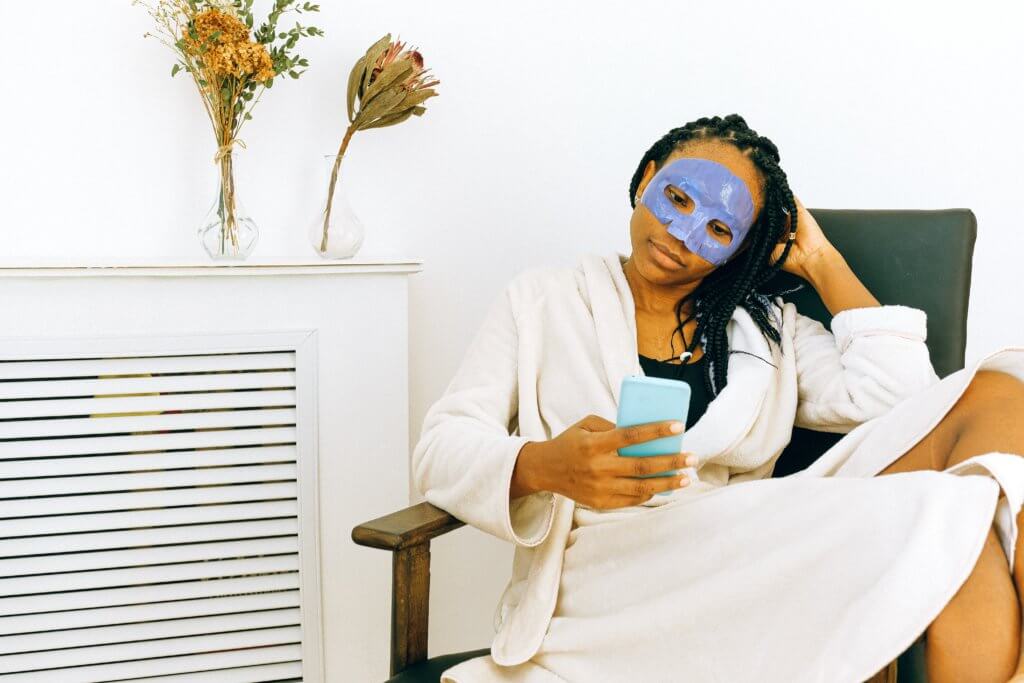 african-american-woman-in-bathrobe-and-sheet-mask
