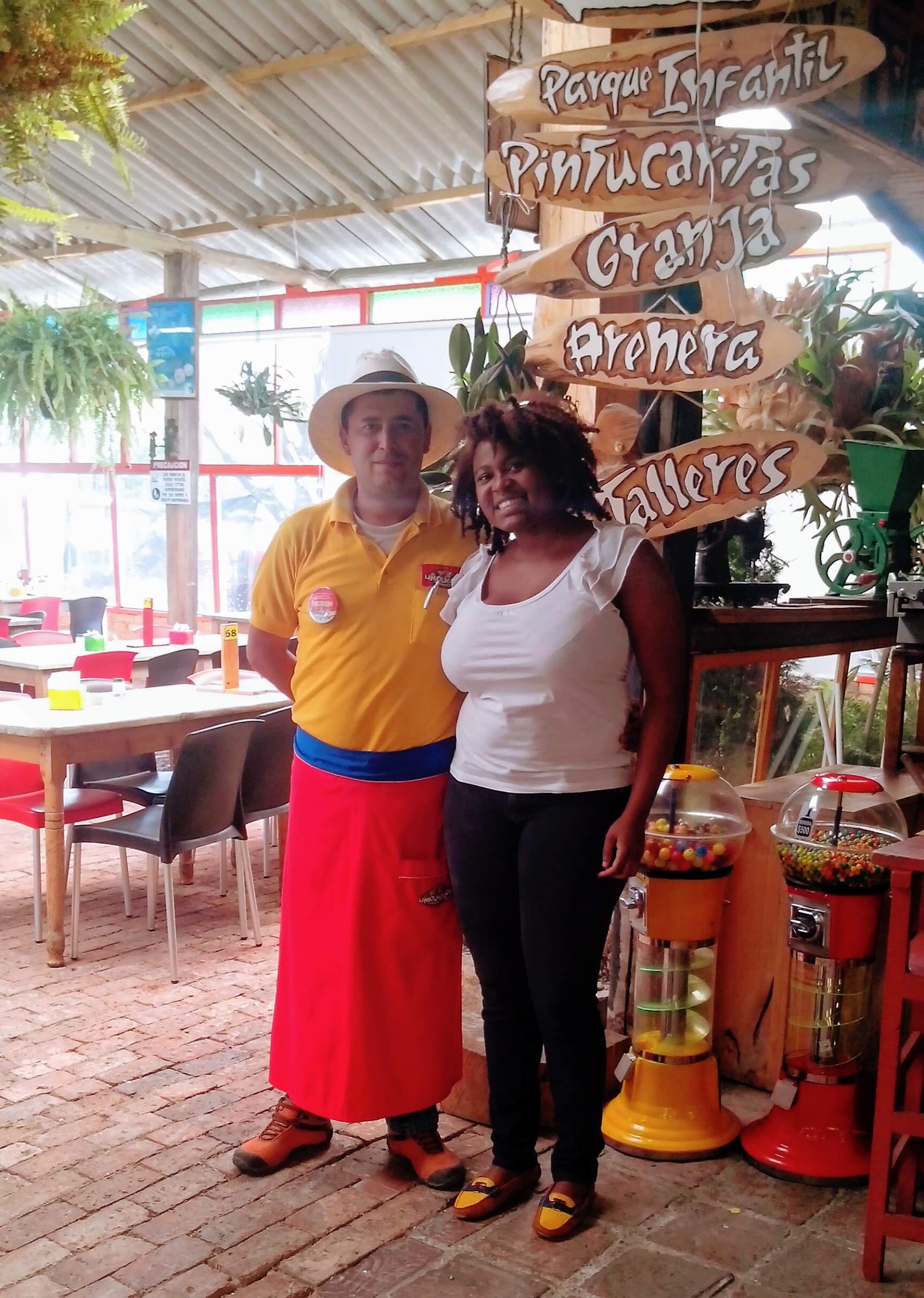 Jamaican Solo Traveller Diedre McLeod poses with the host of traditional Colombian restaurant, La Molienda
